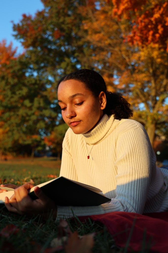 Lifestyle portrait reading in autumn park