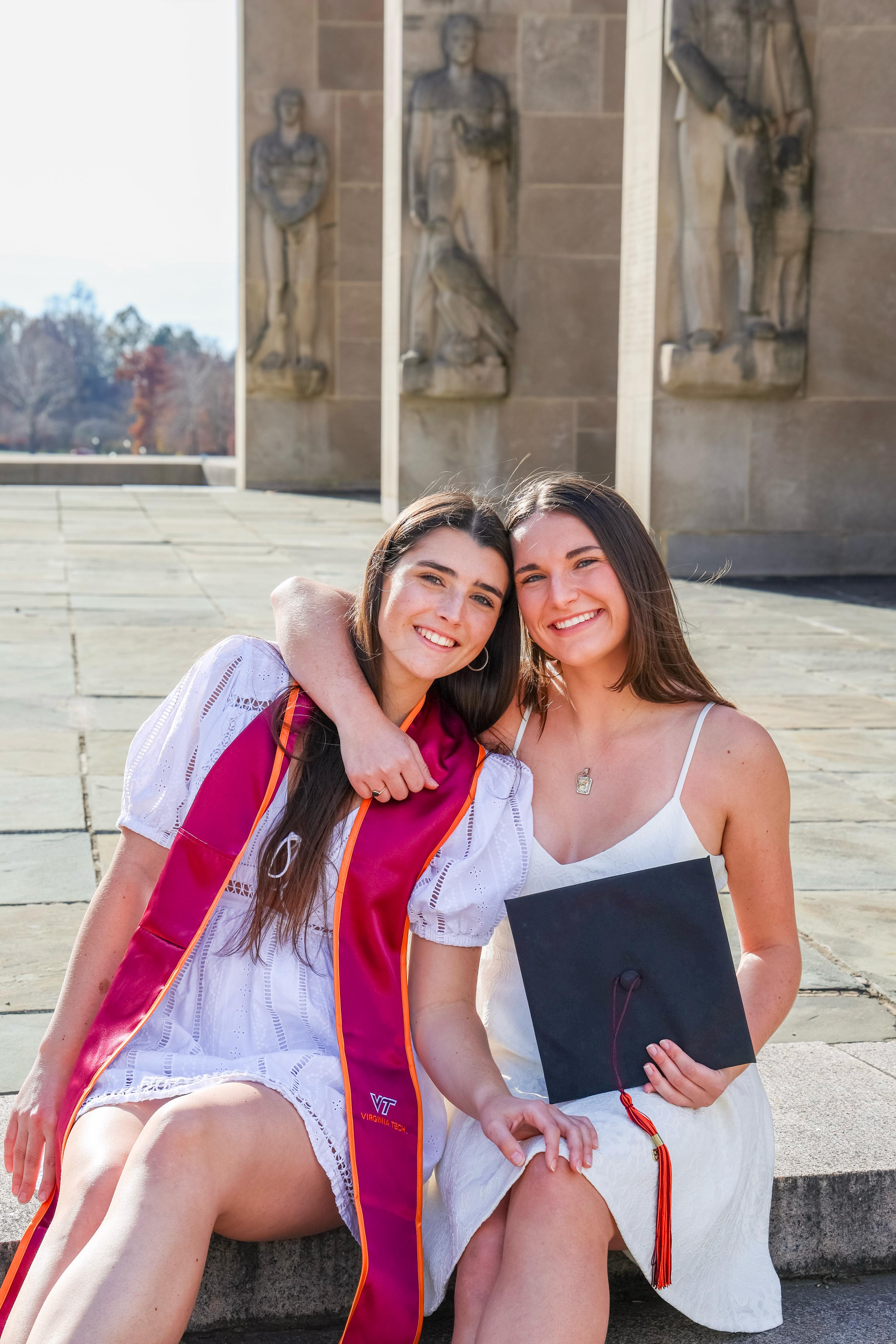 Two graduates posing together on campus at Virginia Tech