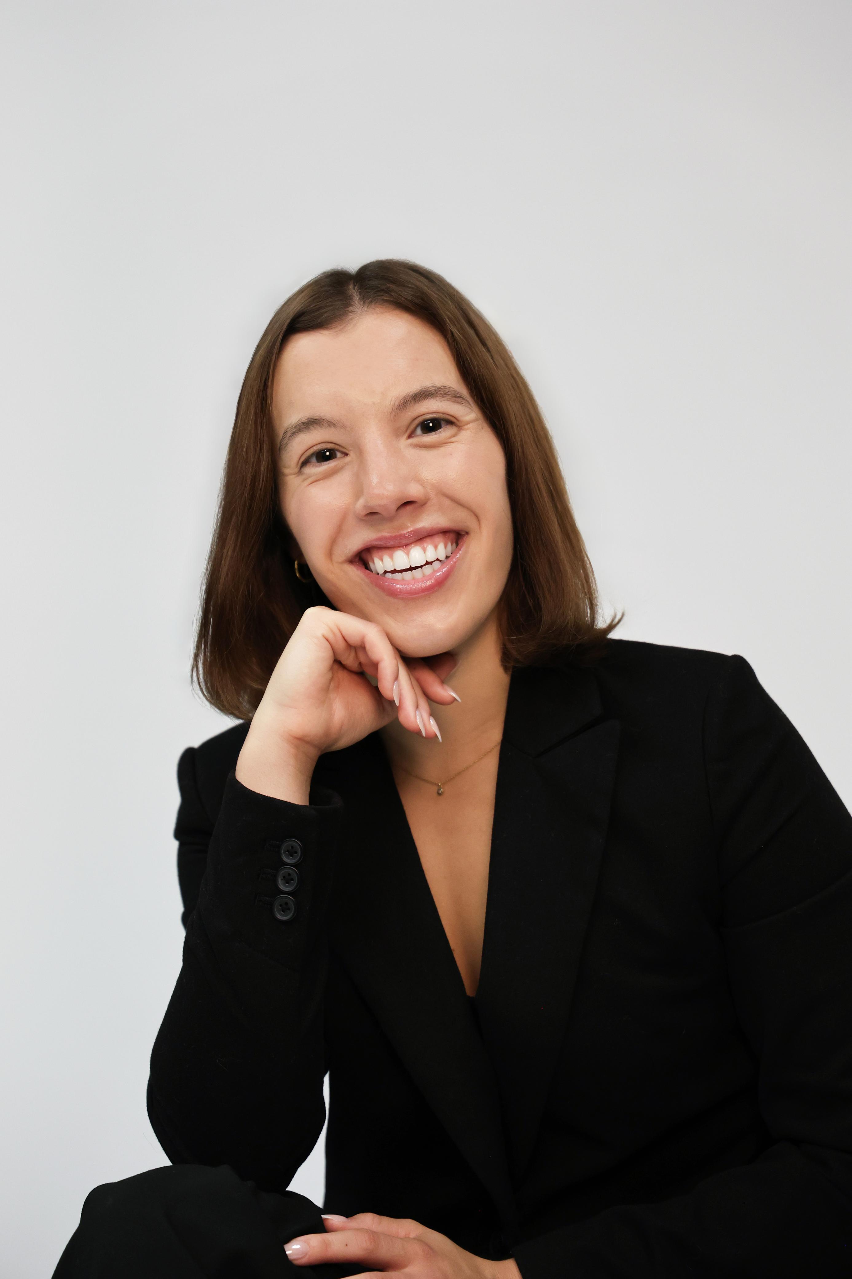 Professional studio headshot against a light background